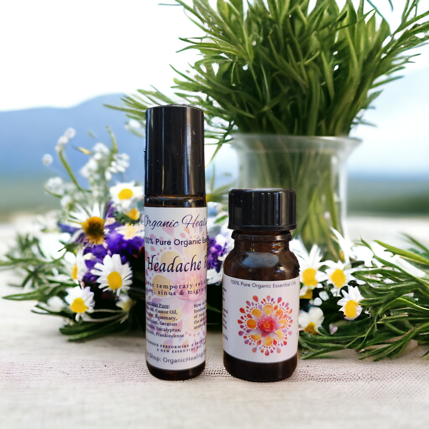 Headache Soothing essential oil roller and inhaler by Organic Healing Oils placed among fresh lavender and daisies, portraying natural ingredients for soothing relief.