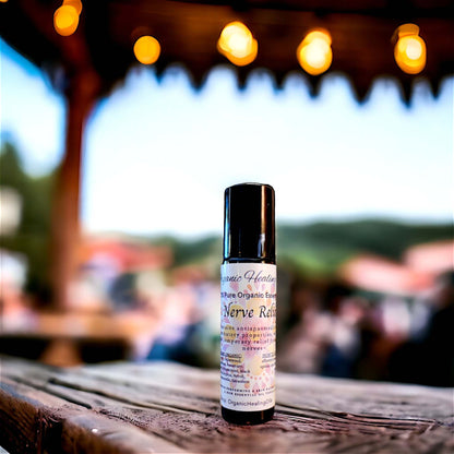 Organic Healing Oil's Nerve Calming Oil 10ml Roller bottle placed on a dark rustic wood table.