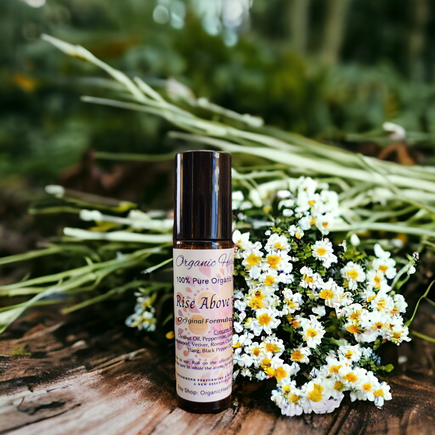 Rise Above Pain, Pain Soothing Essential Oil 10ml Roller pictured with chamomile flowers