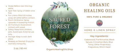 Label for Sacred Forest Home & Linen Spray by Organic Healing Oils. The label features a misty forest scene with lush greenery. Instructions for use are on the left. The product is described as 100% pure and organic, highlighting key ingredients like cedarwood, frankincense, black spruce, cinnamon bark, blue tansy, other proprietary fragrances, and witch hazel.