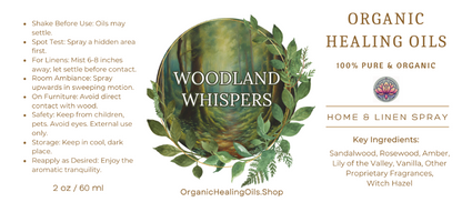 Label for Woodland Whispers Home & Linen Spray by Organic Healing Oils. The label features a serene forest scene with lush foliage. Instructions for use are on the left. The product is described as 100% pure and organic, highlighting key ingredients like sandalwood, rosewood, amber, lily of the valley, vanilla, other proprietary fragrances, and witch hazel.