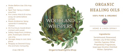 Label for Woodland Whispers Home & Linen Spray by Organic Healing Oils. The label features a serene forest scene with lush foliage. Instructions for use are on the left. The product is described as 100% pure and organic, highlighting key ingredients like sandalwood, rosewood, amber, lily of the valley, vanilla, other proprietary fragrances.